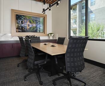 a conference room with a wooden table and chairs